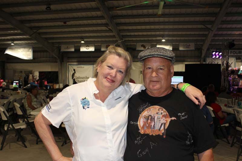 A man and a woman are posing for a picture in a room.