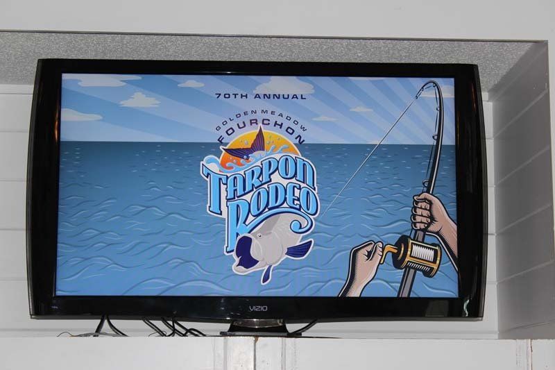 A television screen shows a cartoon of a person holding a fishing rod