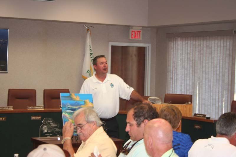 A man is giving a presentation in front of a group of people.