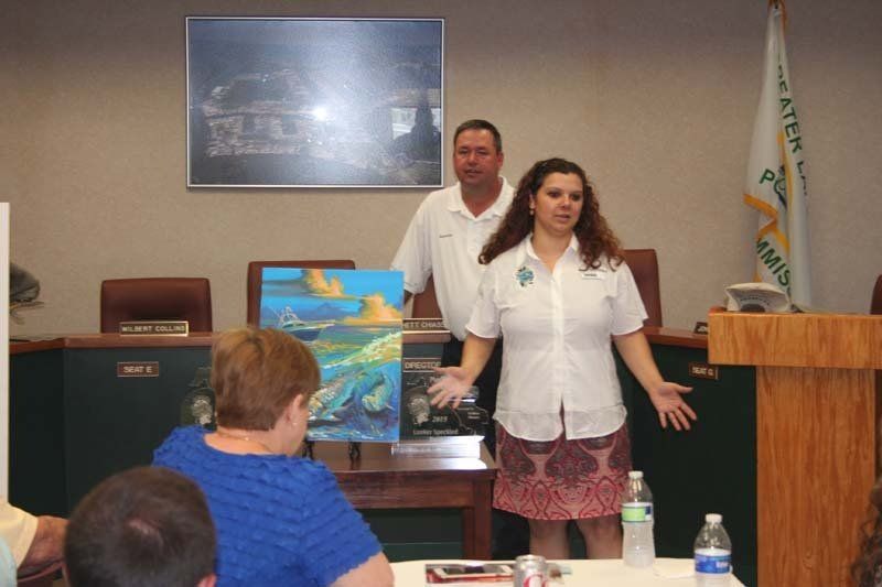 A woman is giving a presentation in front of a group of people