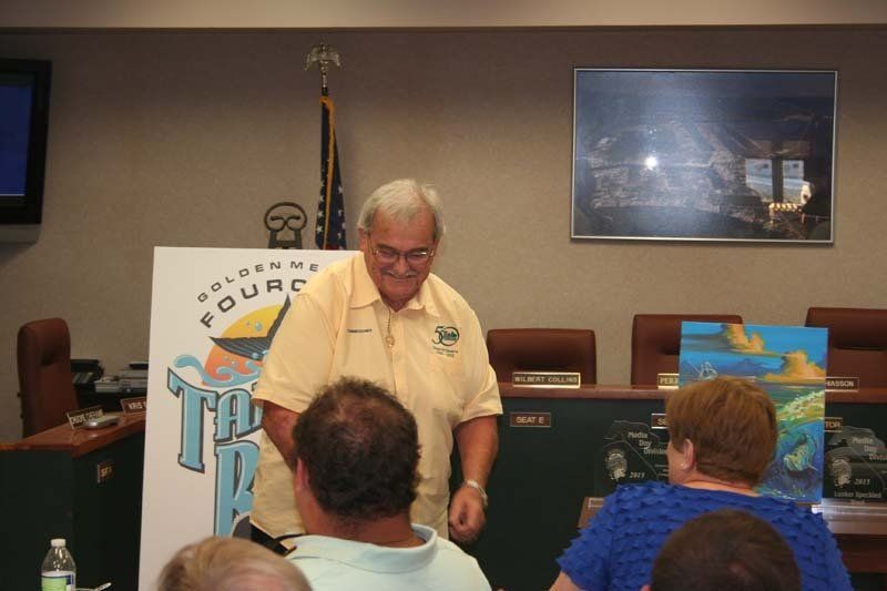 A man stands in front of a sign that says fourc