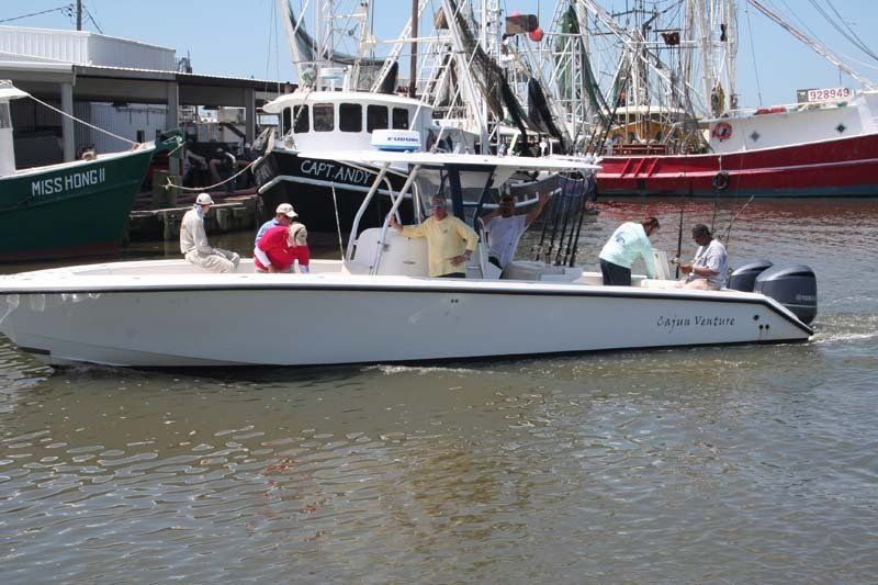 A group of people are on a boat in the water.