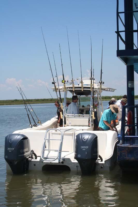 A boat with two yamaha engines is in the water