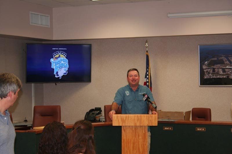 A man is standing at a podium in front of a group of people
