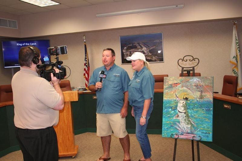 A man and a woman are being interviewed by a cameraman