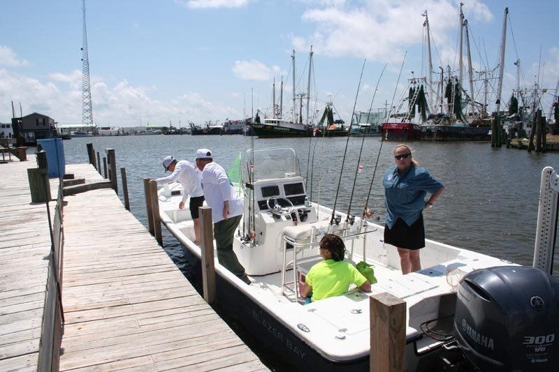 A boat with a yamaha engine is docked at a dock