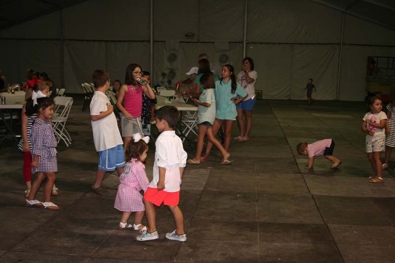 A group of children are dancing on a dance floor.