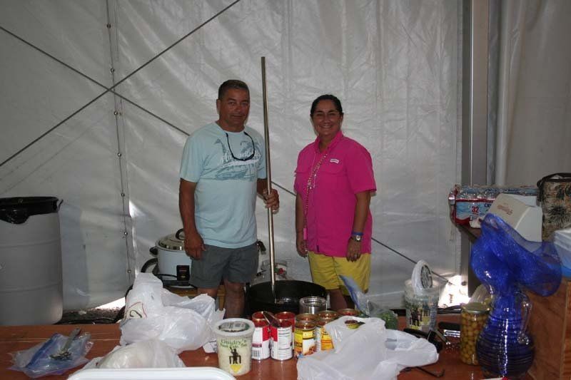 A man and a woman are standing next to each other in a tent