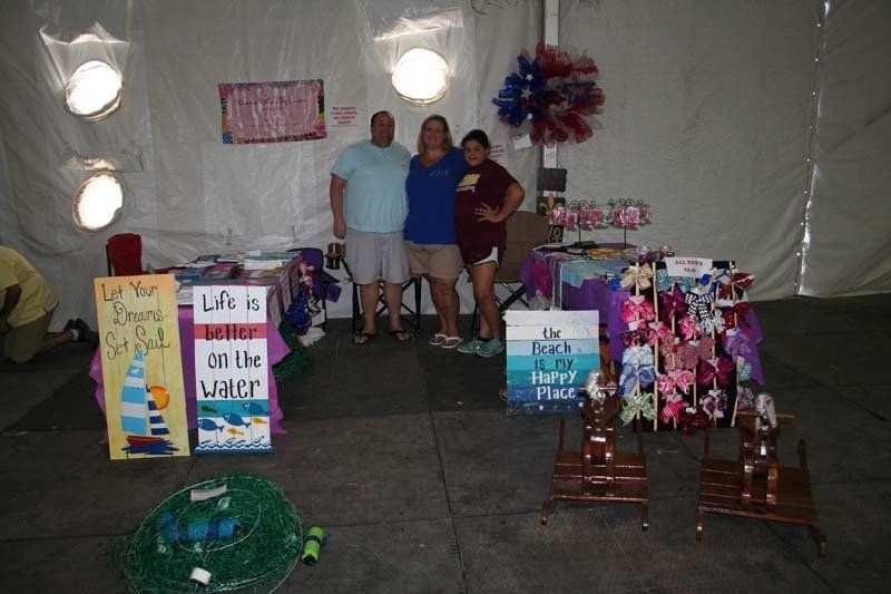 A group of people standing in front of a sign that says lake of the water