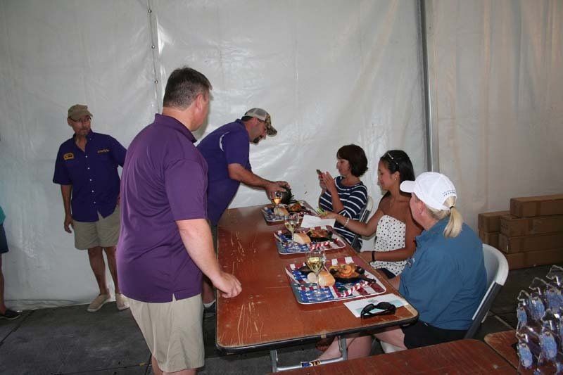 A group of people are sitting at a table eating food