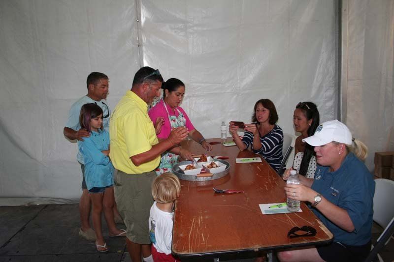 A group of people are sitting around a table eating food