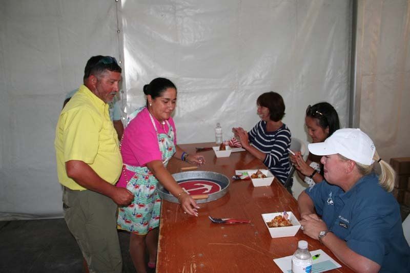 A group of people are sitting around a table eating food