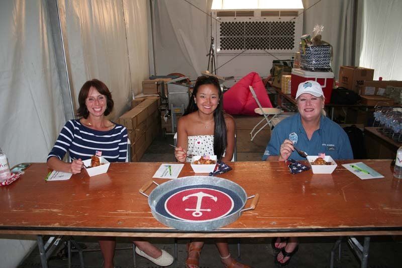 A group of people are sitting at a table eating food