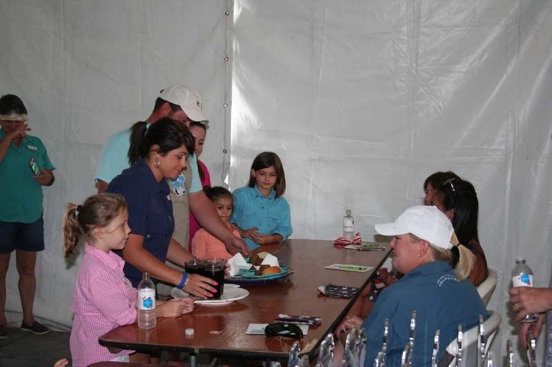 A group of people sitting around a table with a plate of food on it