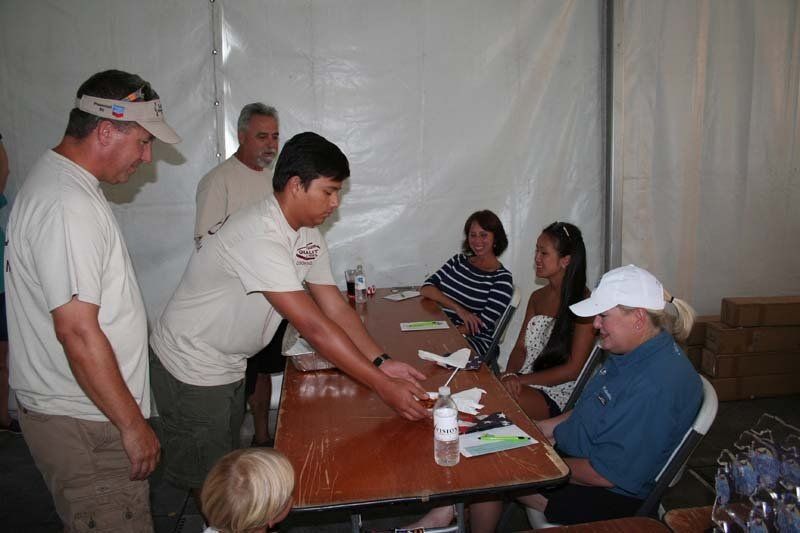 A group of people are sitting at a table talking to each other.