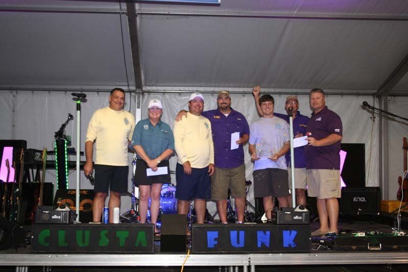 A group of men standing on a stage in front of a sign that says punk