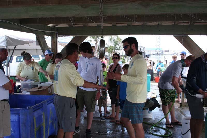 A group of people are standing under a covered area.