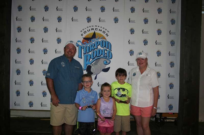 A group of people posing for a picture in front of a banner that says coupon dudes