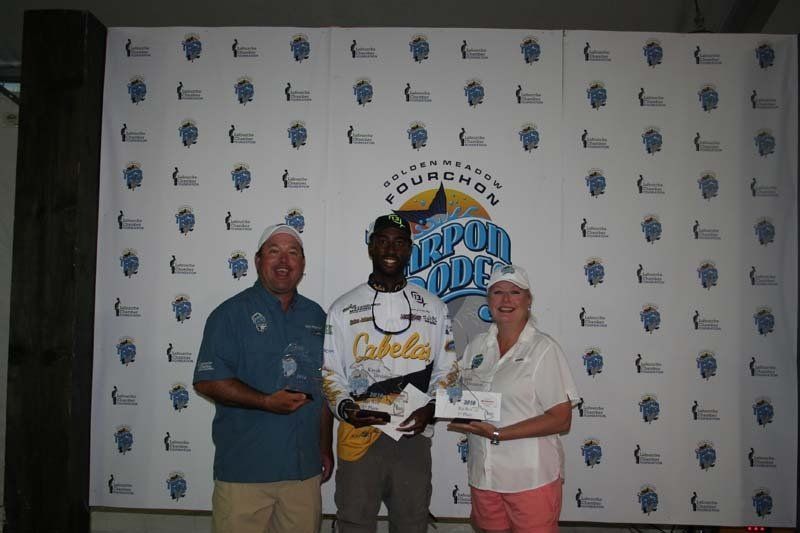Two men and a woman are standing in front of a wall that says coupon code