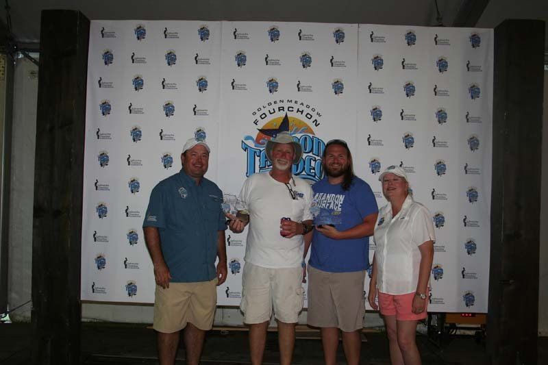 A group of people standing in front of a wall with the word florida on it