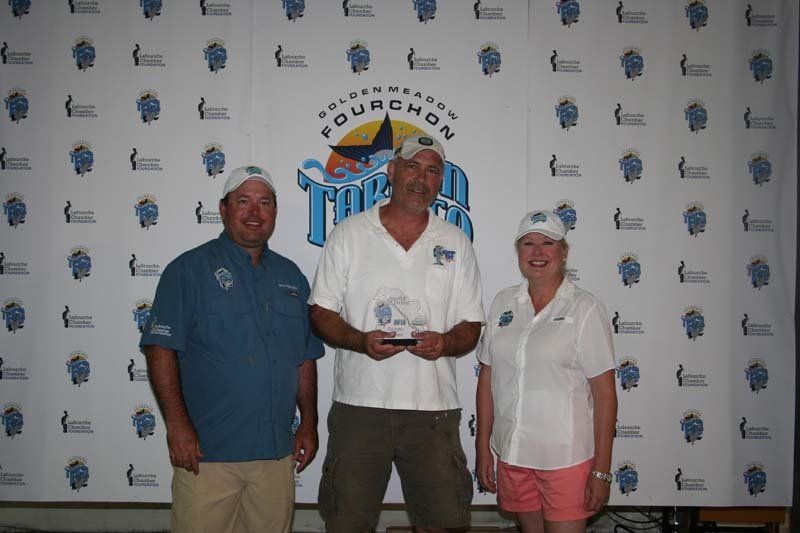 Three people standing in front of a wall that says fournor