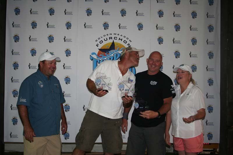 A group of people standing in front of a wall that says fourchan