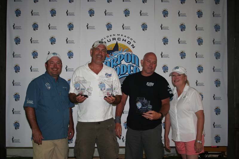 A group of people are posing for a picture in front of a banner that says ' gulfport golden '