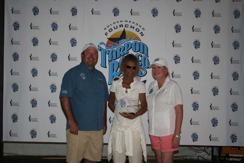 A group of people standing in front of a wall that says torpedo pass