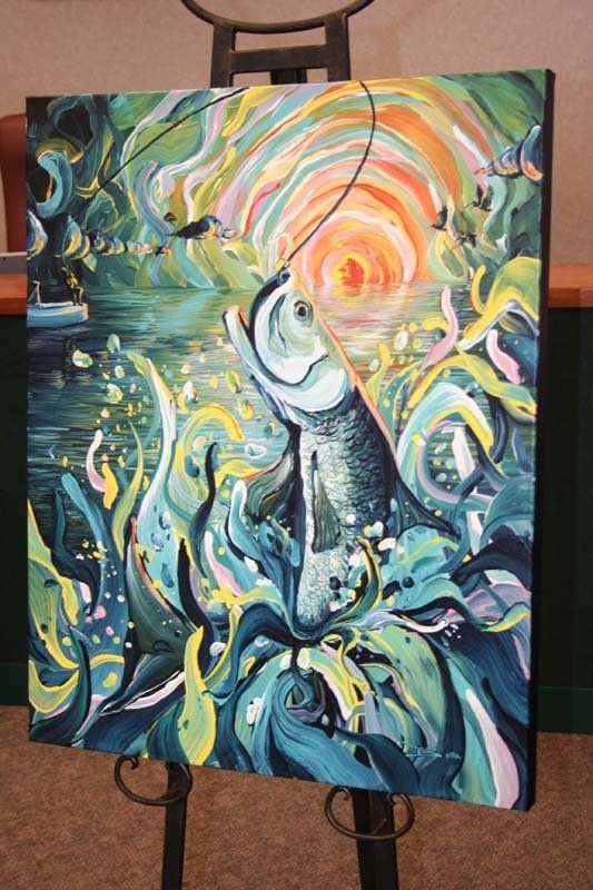 A colorful painting of a fish on an easel