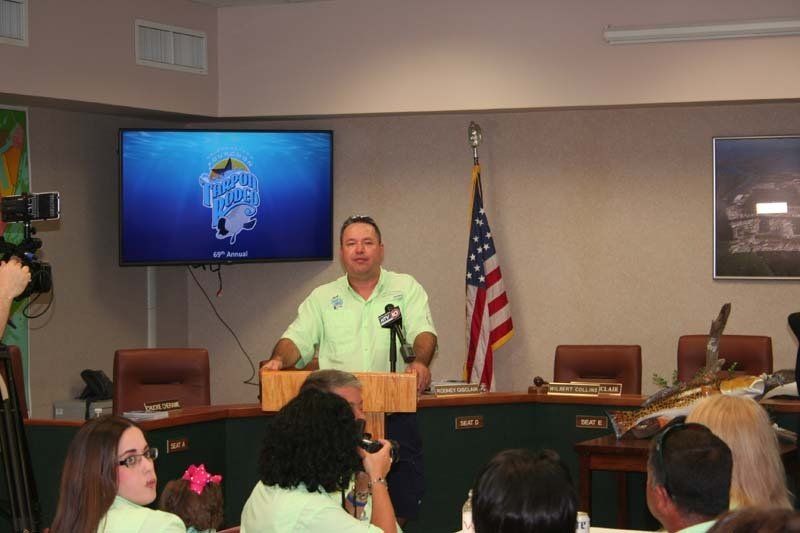 A man is giving a speech in front of a group of people