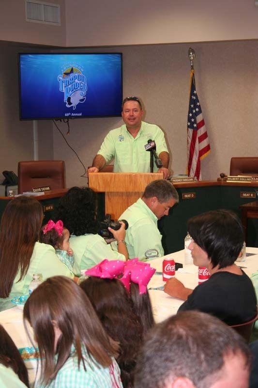 A man stands at a podium in front of a group of people