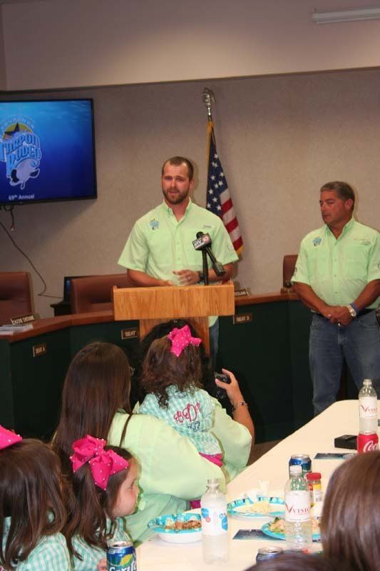 A man stands at a podium in front of a group of people