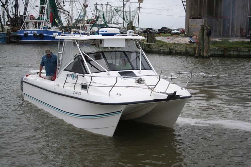 A white boat is floating on a body of water
