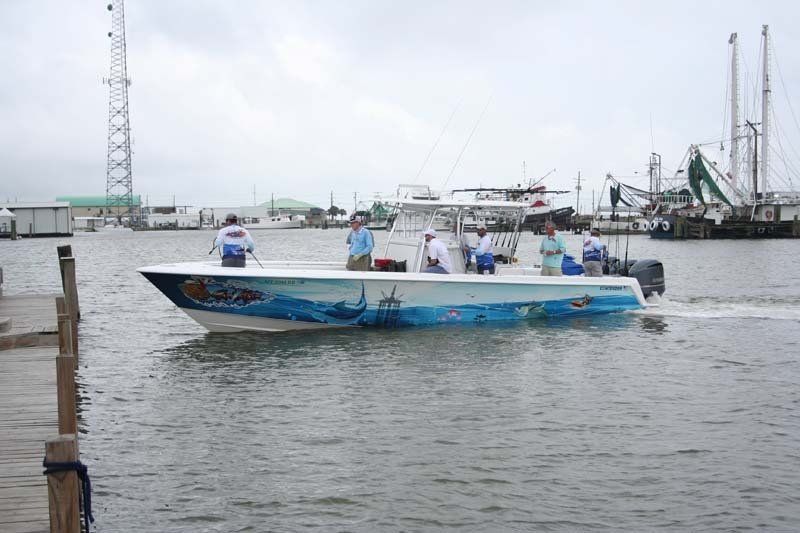 A boat is floating on the water near a dock.