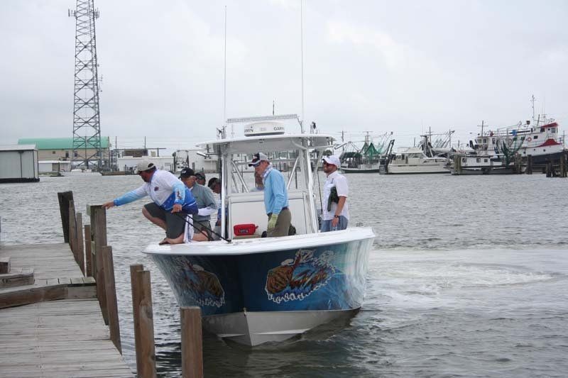 A group of people are on a boat in the water.