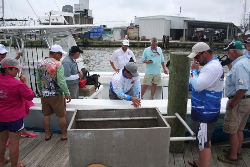 A group of people are standing on a dock next to a boat.