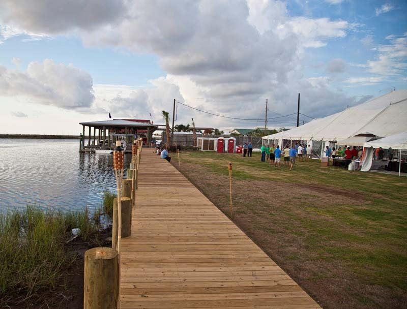 A wooden dock leading to a large body of water.