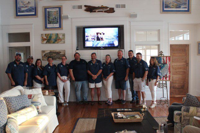 A group of people standing in front of a television in a living room