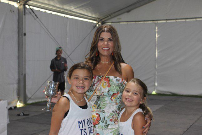 A woman and two little girls are posing for a picture.