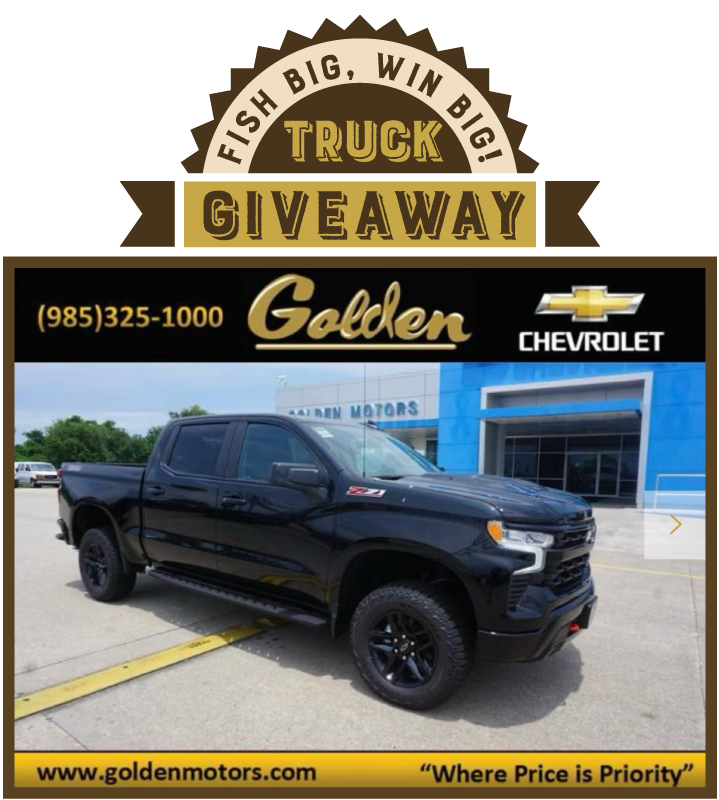 A black truck is parked in front of a Golden Motors Chevrolet dealership