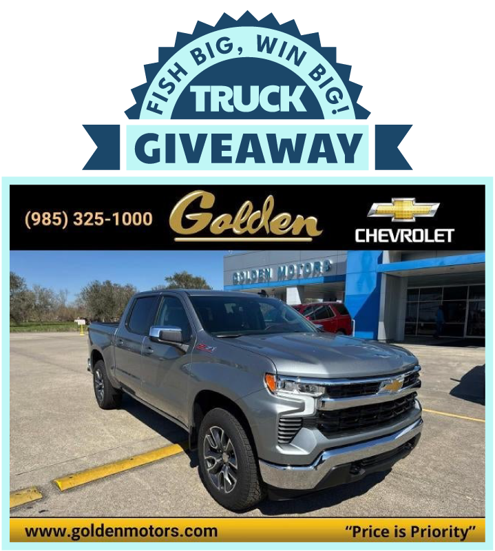 A black truck is parked in front of a Golden Motors Chevrolet dealership