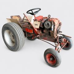 Red vintage lawn tractor with oversized rear tires on a white background
