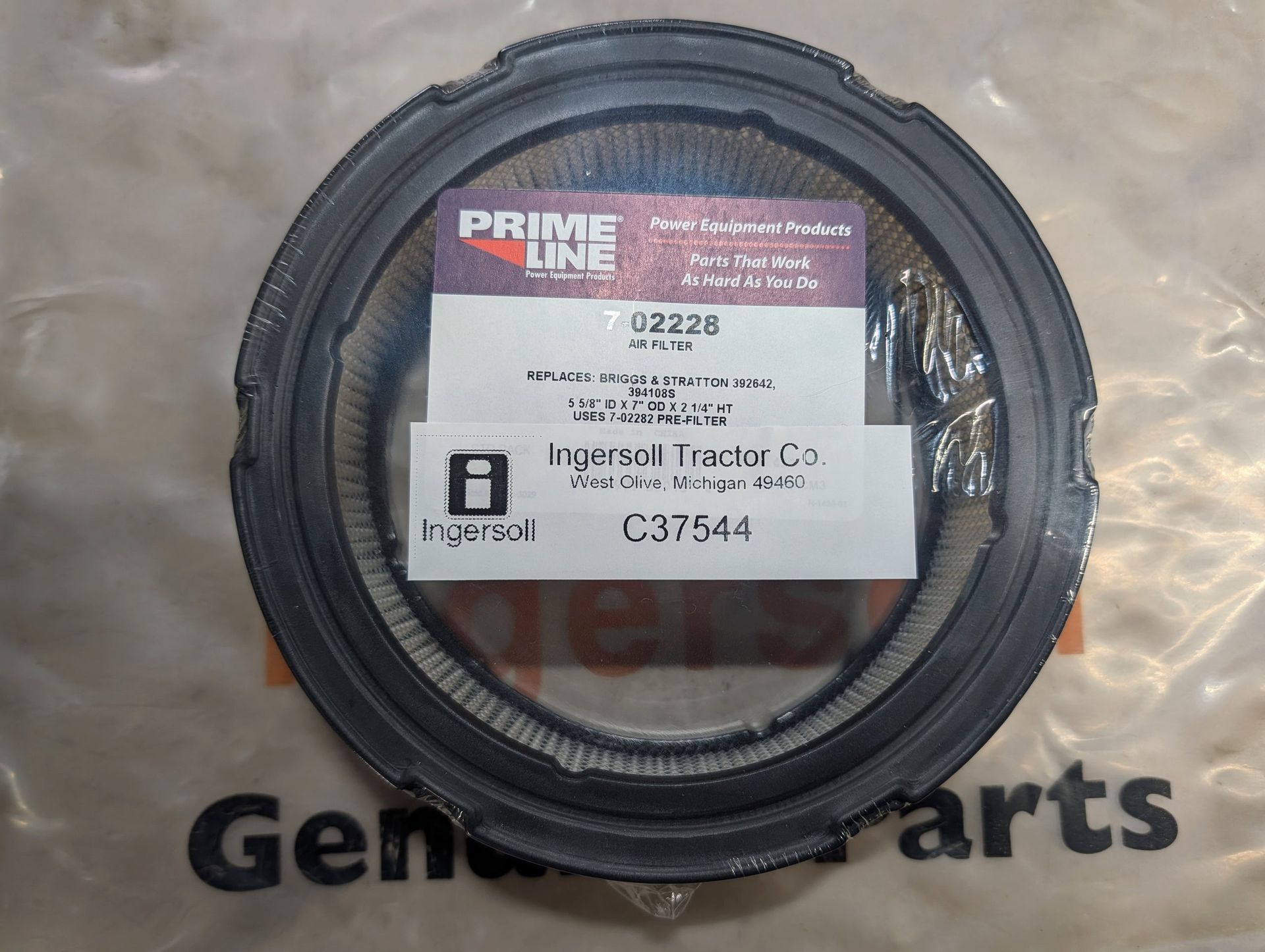 Black plastic gear or pulley with a white label on a clear package labeled 