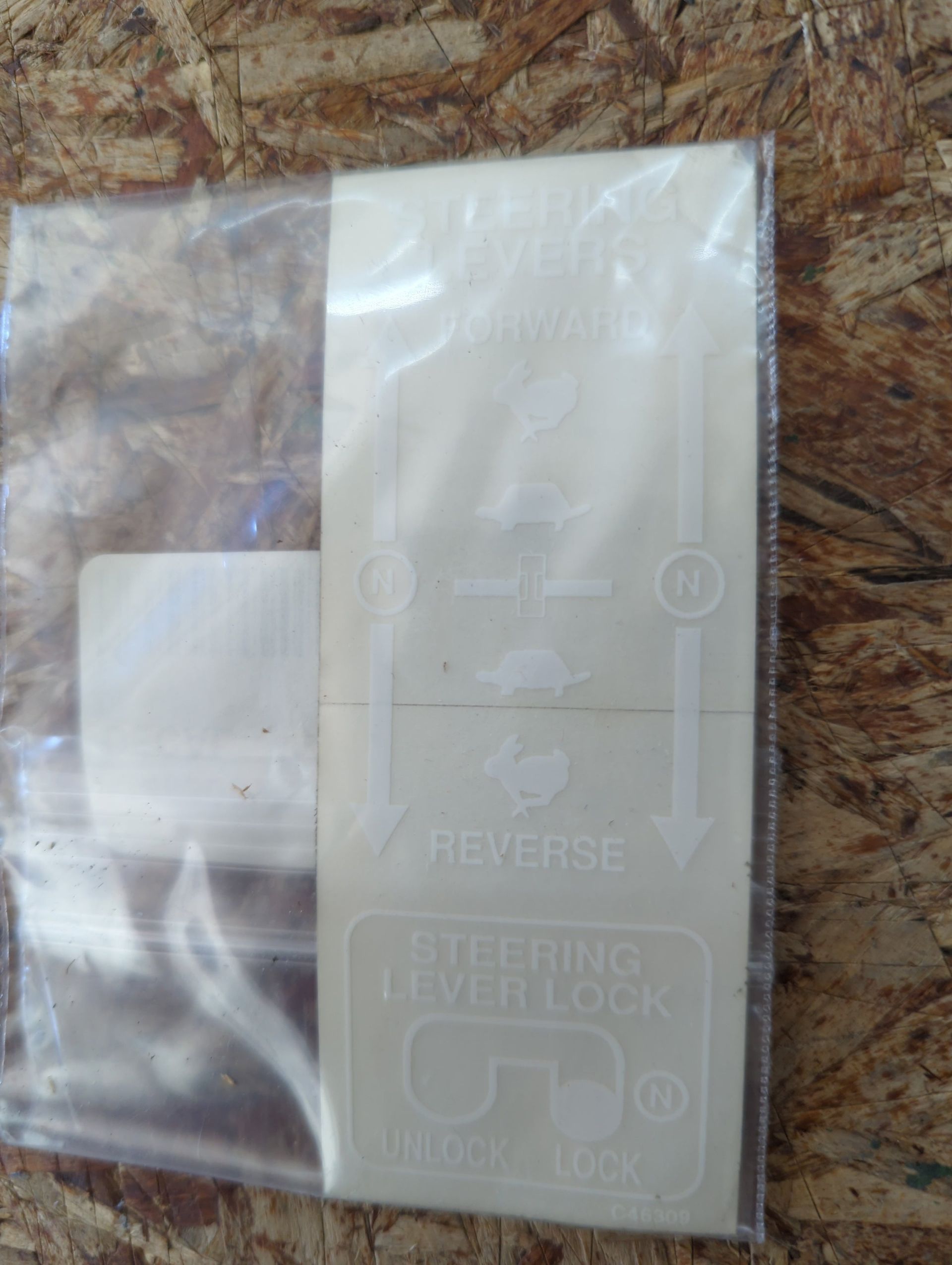 Clear plastic adhesive pouch with printed instructions on a marble surface