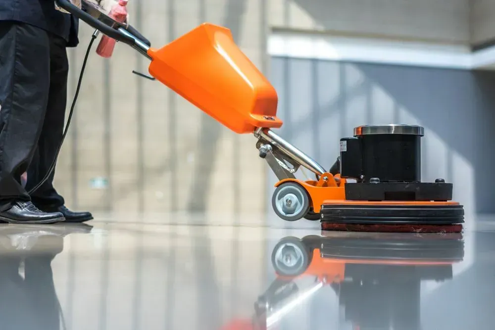 Person Cleaning a Glossy Floor With an Floor Buffer Machine — Jamac Cleaning Services in Chisholm, NSW