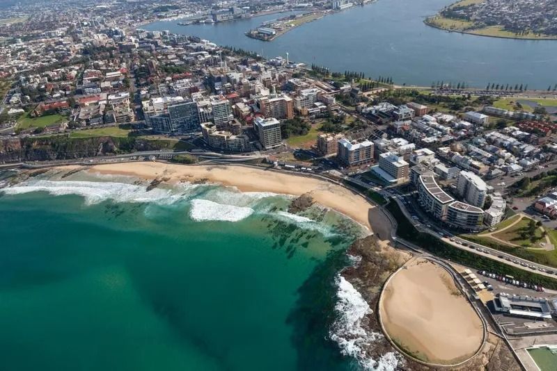 Aerial View of a Coastal City With a Beach — Jamac Cleaning Services in Newcastle, NSW