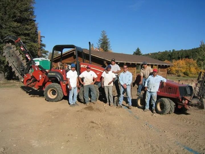 A group of men standing in front of a tractor
