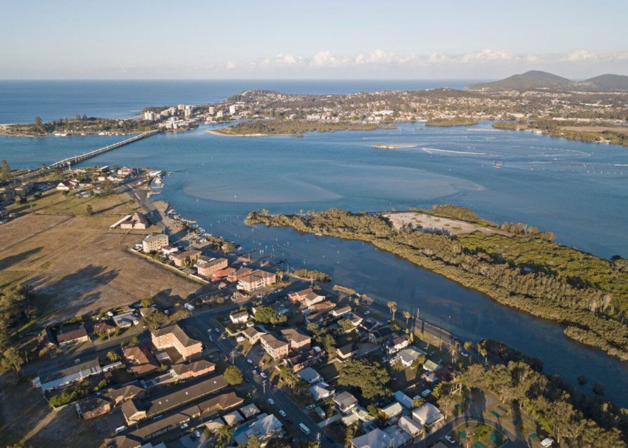 An Aerial View of A Large Body of Water Surrounded by Houses and Trees — Shearwater Engineering in Forster, NSW