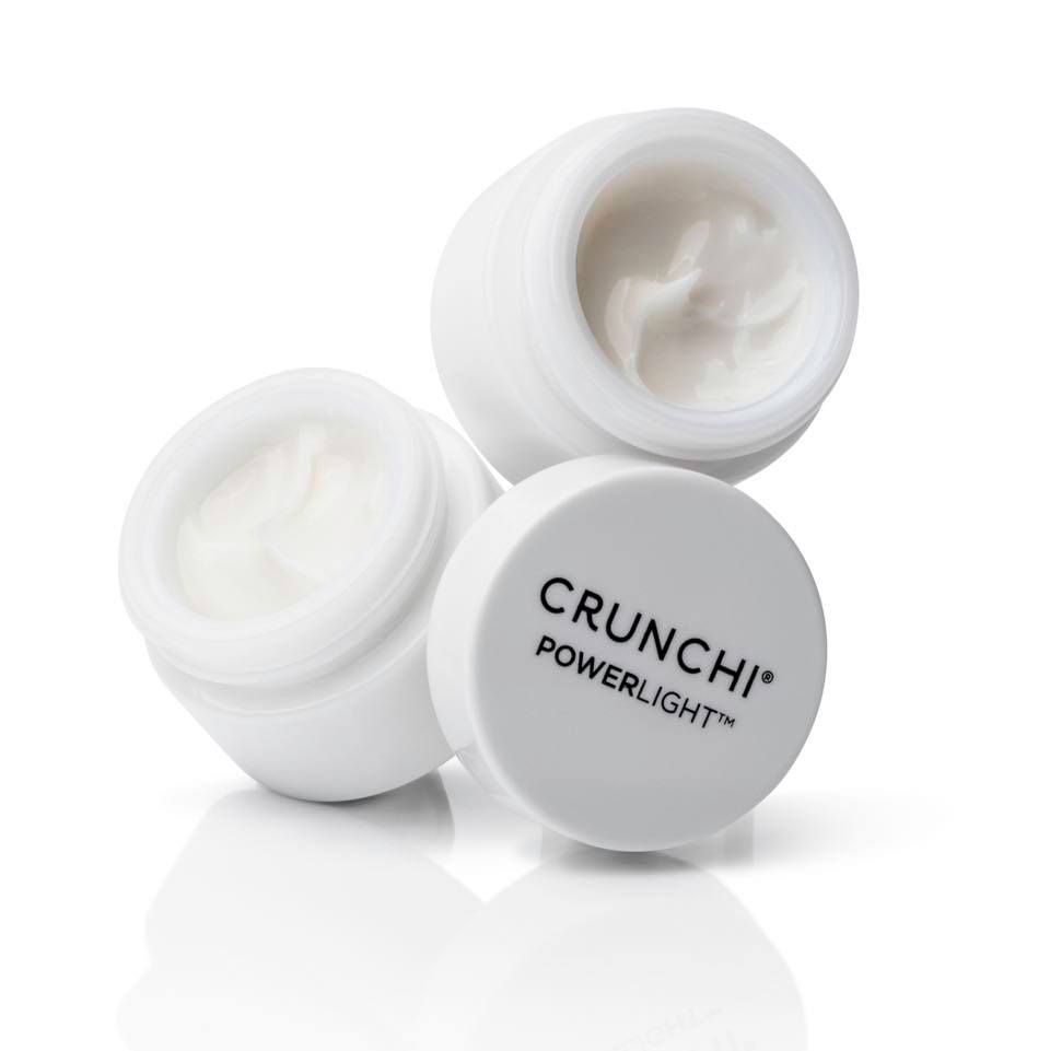 A tube of truaura day lotion sitting on a white surface.