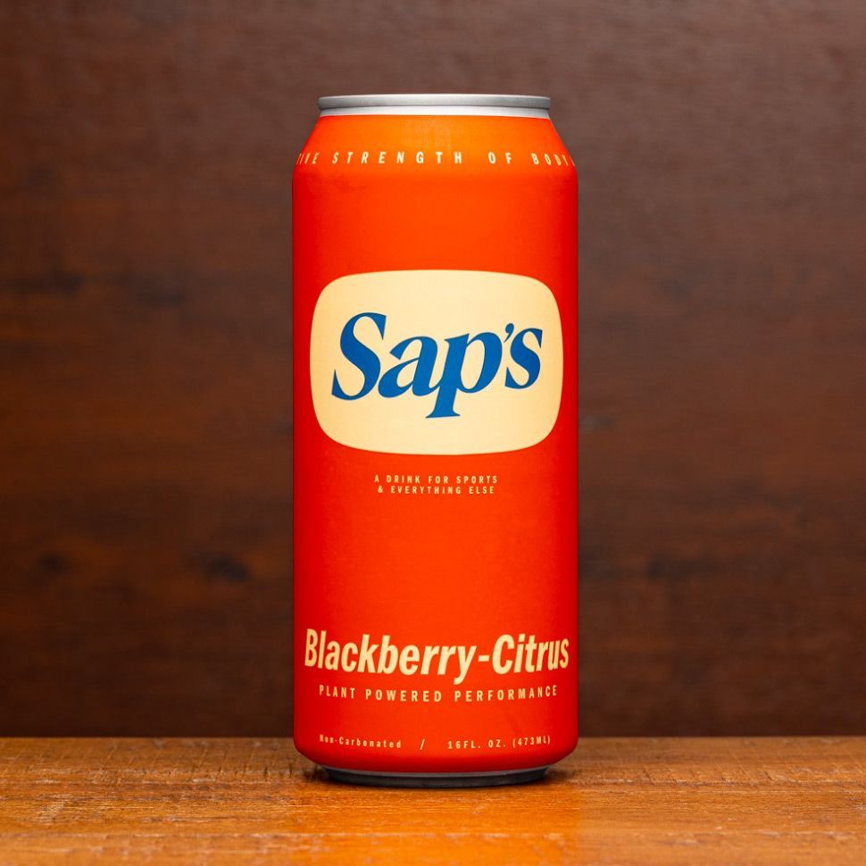 A can of sap 's blackberry citrus sits on a wooden table